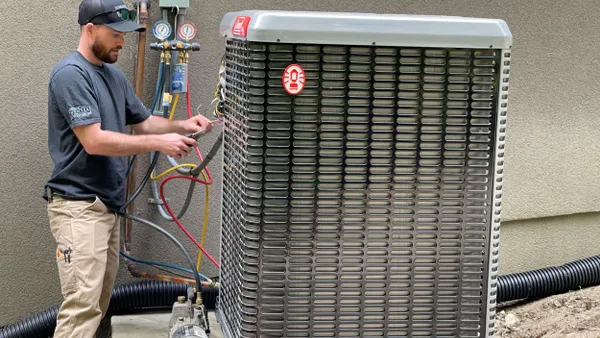 A technician installs a heat pump.