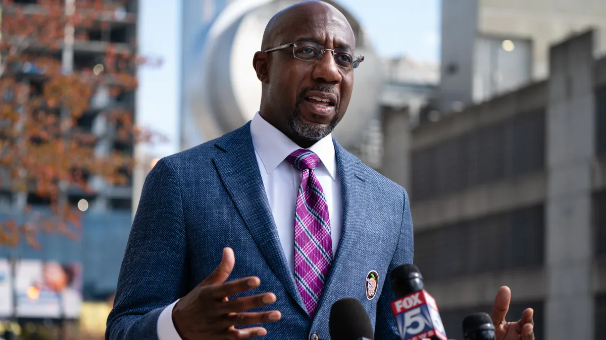 Sen. Raphael Warnock at a podium.