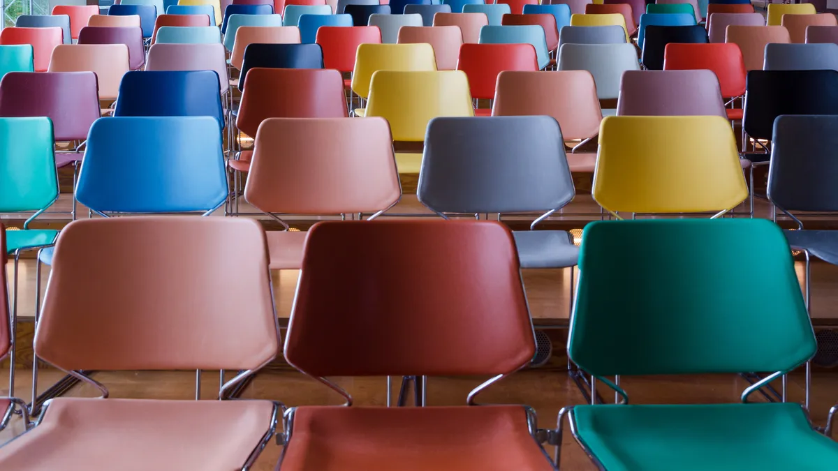 Rows of colorful empty chairs.