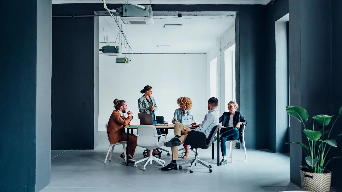 Employees engaged in a discussion at the office.