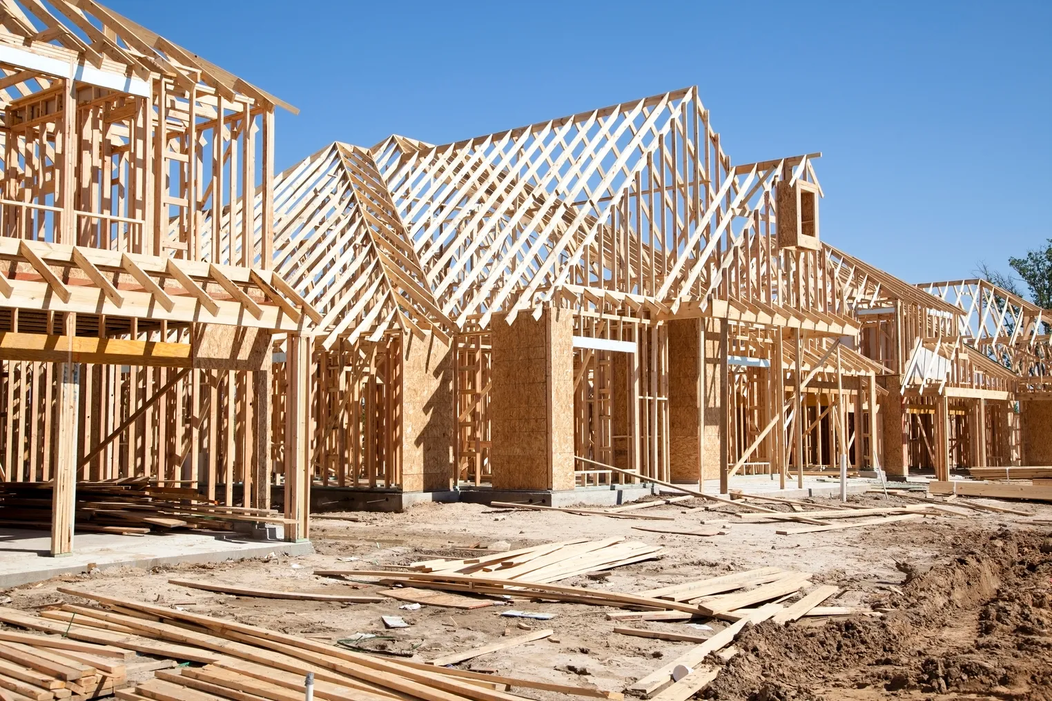 New homes construction site. Framed houses. Lumber. Building. - stock photo.