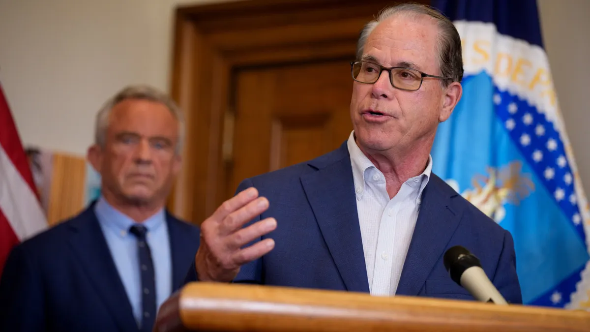 A man speaks at a podium.