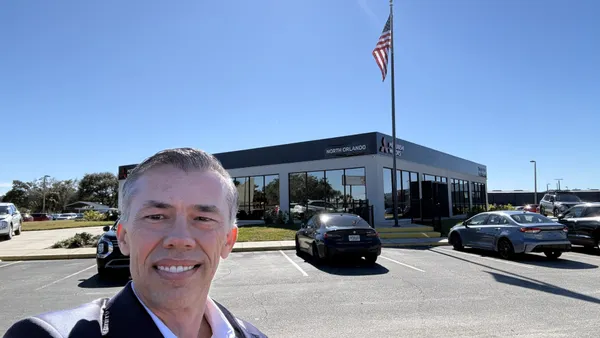Florida car dealer U.S. Marine outside his Orlando store.