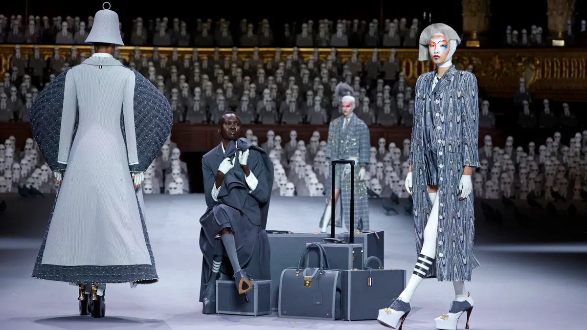 Models are seen wearing Thom Browne clothing during a runway show.