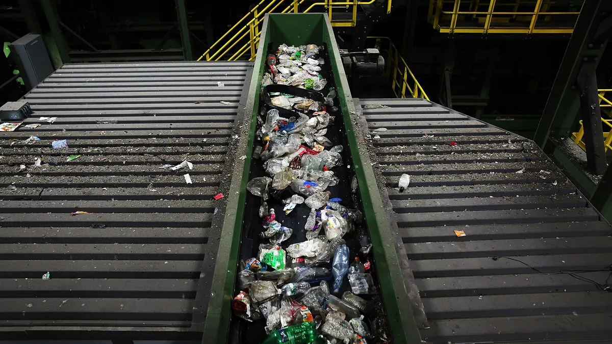 Plastic bottles on conveyor belt within industrial facility