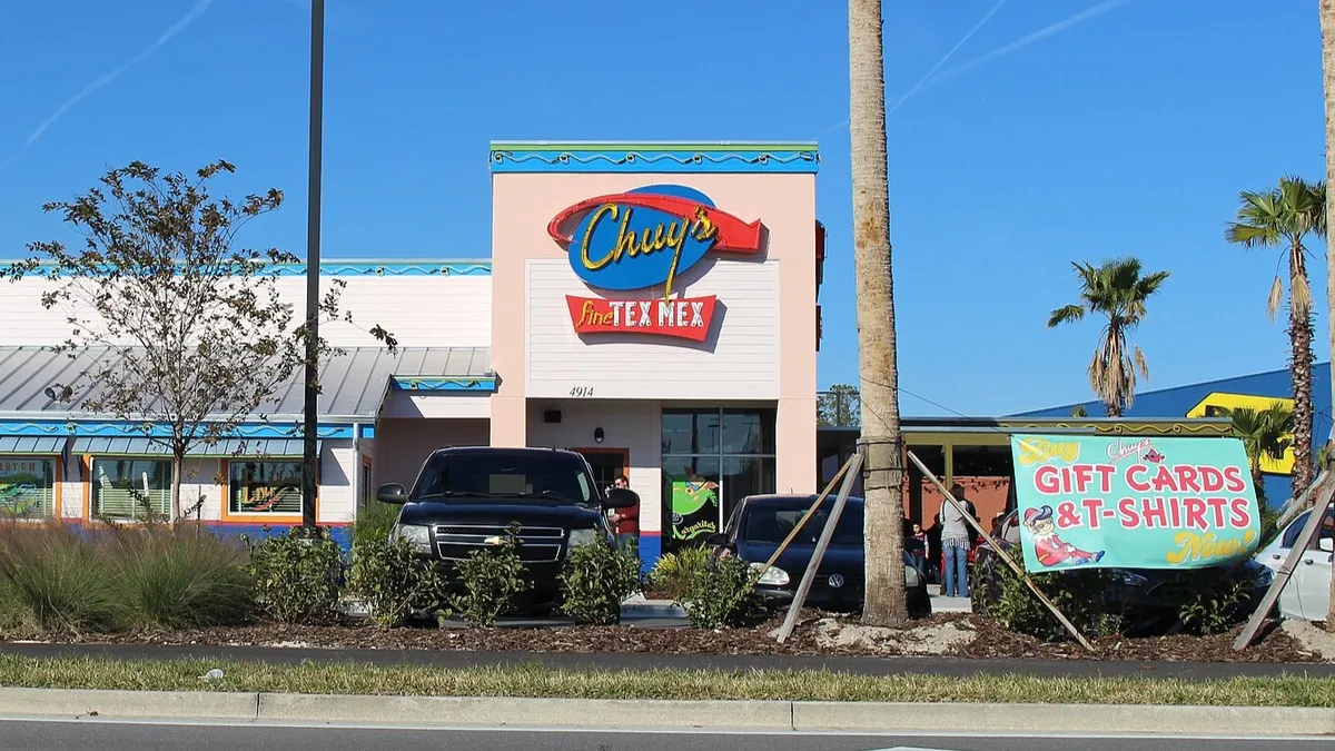 An image of a pink building with a Chuy's sign on the side.