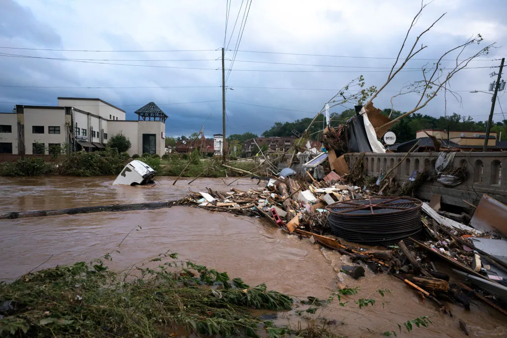 A van flows in floodwaters near the Biltmore Village in the aftermath of Hurricane Helene on September 28, 2024 in Asheville, North Carolina. Hurricane Helene made landfall Thursday night in Florida&#x27;s Big Bend with winds up to 140 mph.