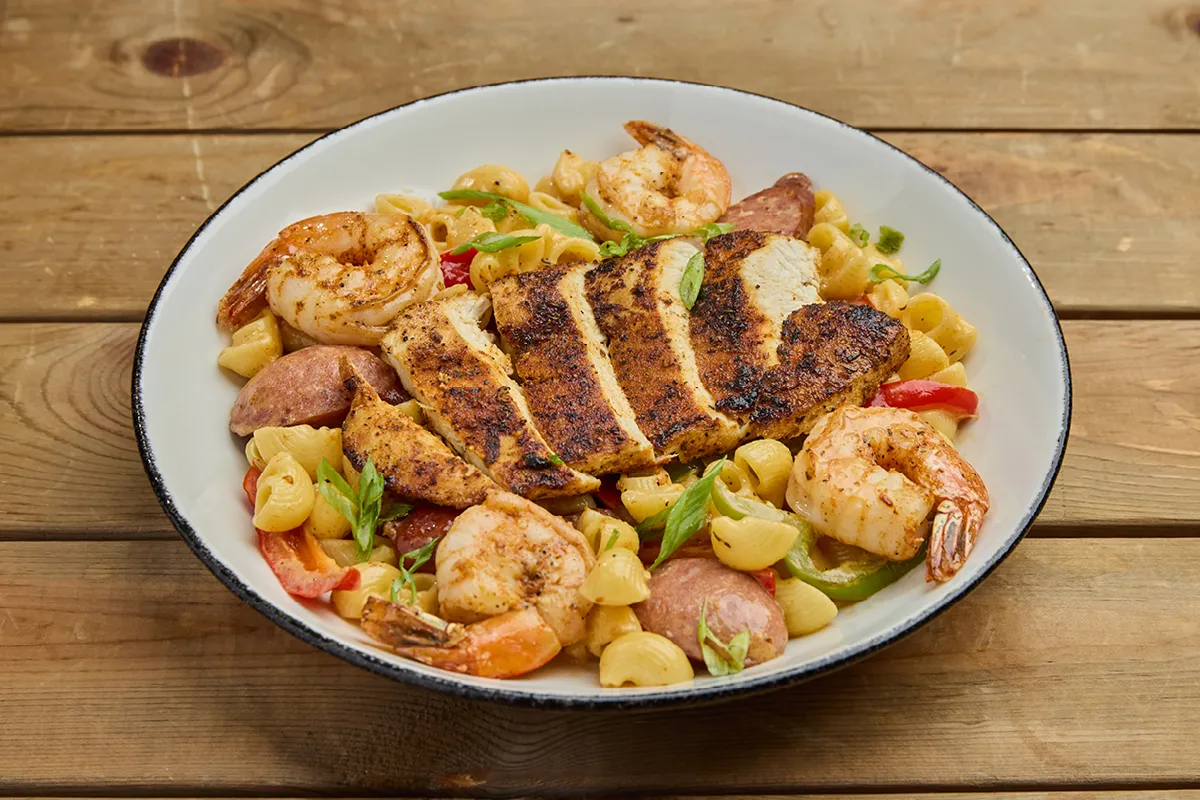 An image of New Orleans Chicken & Shrimp Pasta from Bar Louie in a white bowl