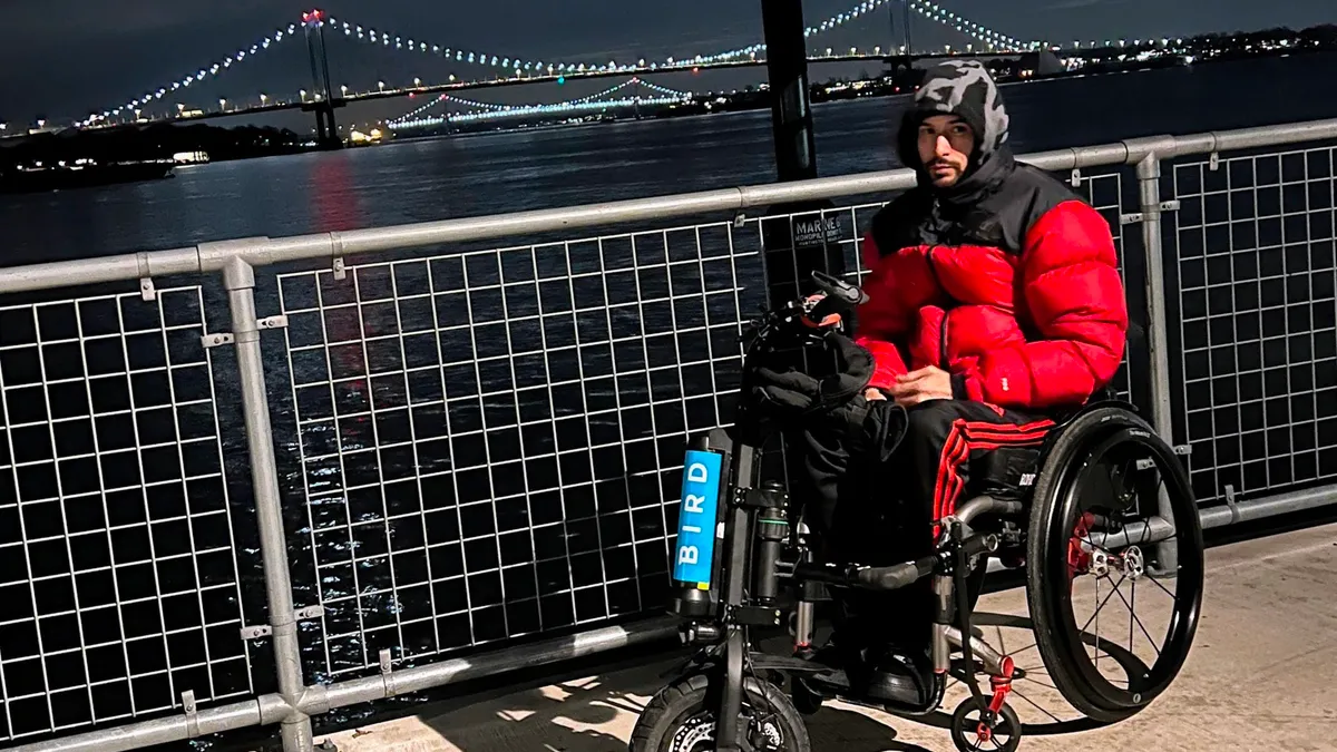 Eduardo Hernandez, a Bronx resident, utilizing one of Bird's motorized attachments for wheelchair users.