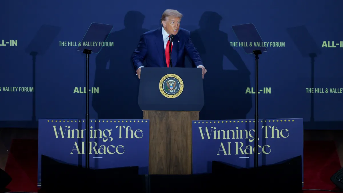 A man speaks at a podium.