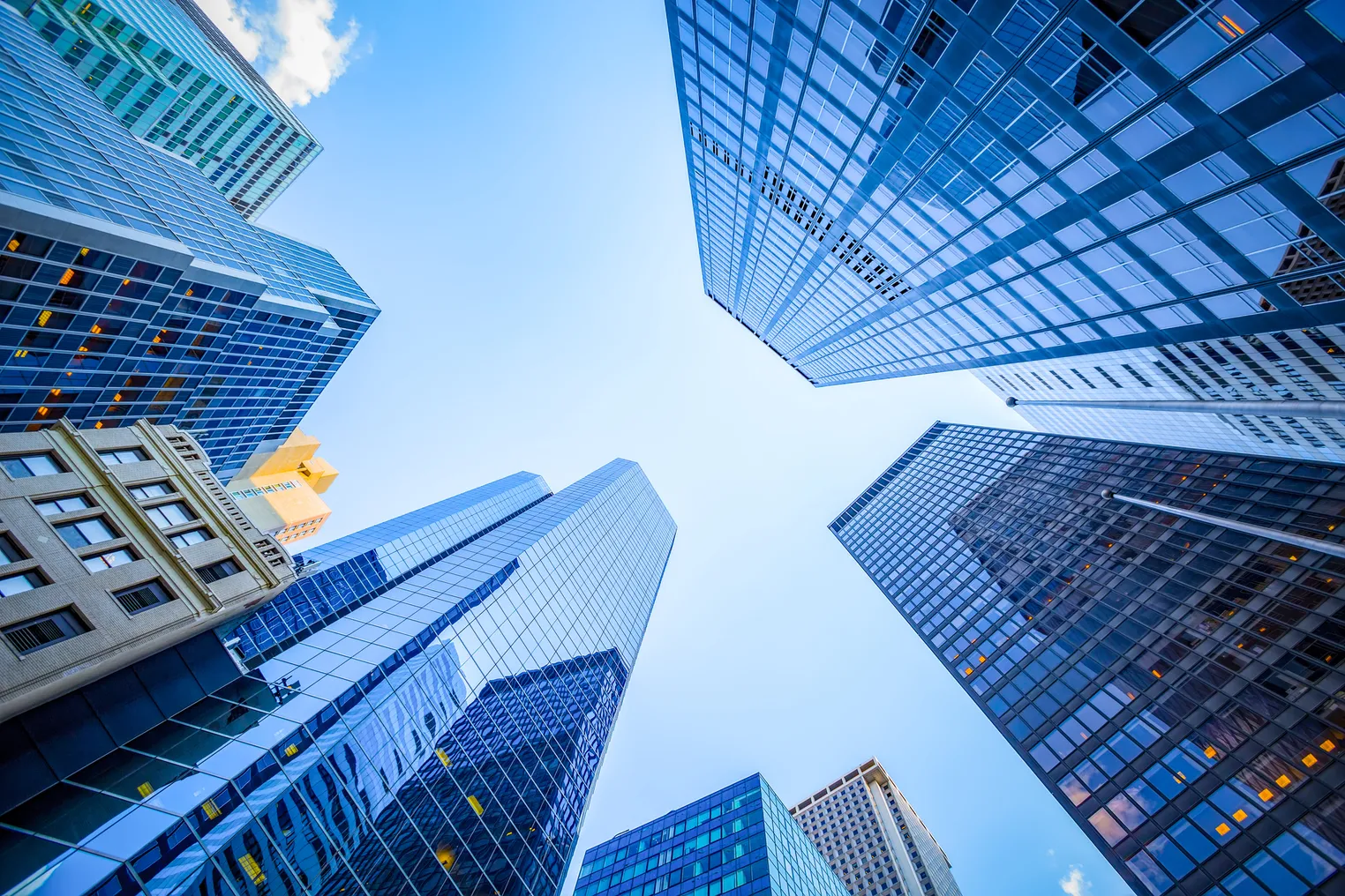 Looking upward at skyscrapers.