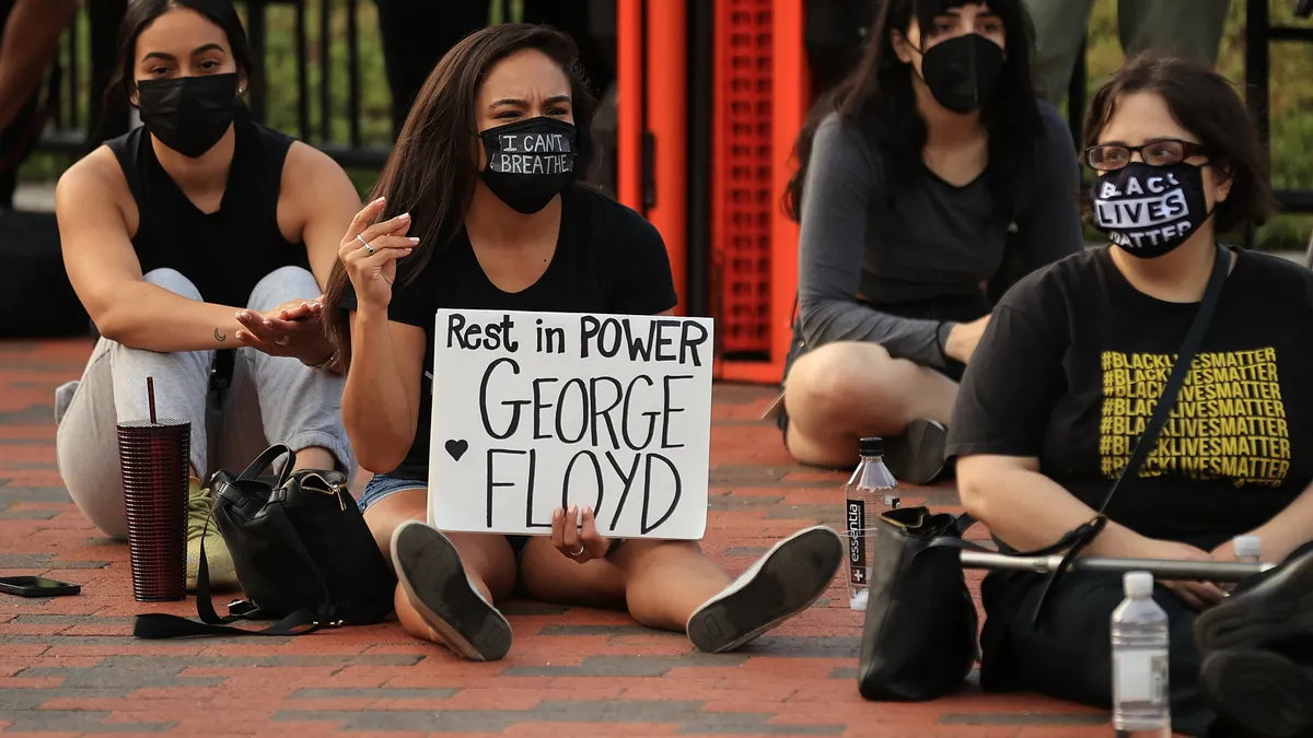 WASHINGTON, DC - MAY 25: People gather for a vigil on the one-year anniversary of George Floyd's murder in Lafayette Square near the White House on May 25, 2021 in Washington, DC.