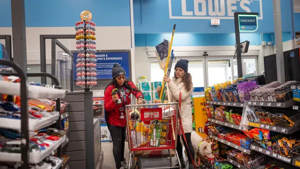 A worker checks out a customer at a Lowe's home improvement store.