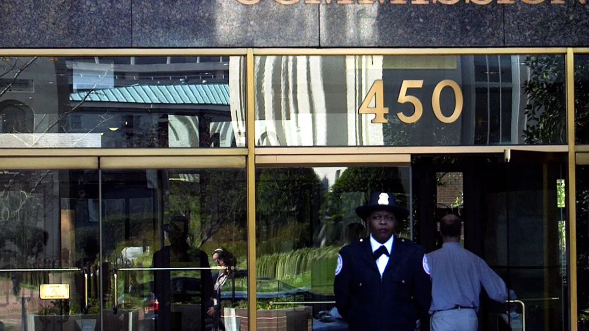 Guard stands in front of Securities and Exchange Commission building.