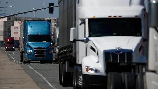 Trucks moving through a port located in Oakland, California.