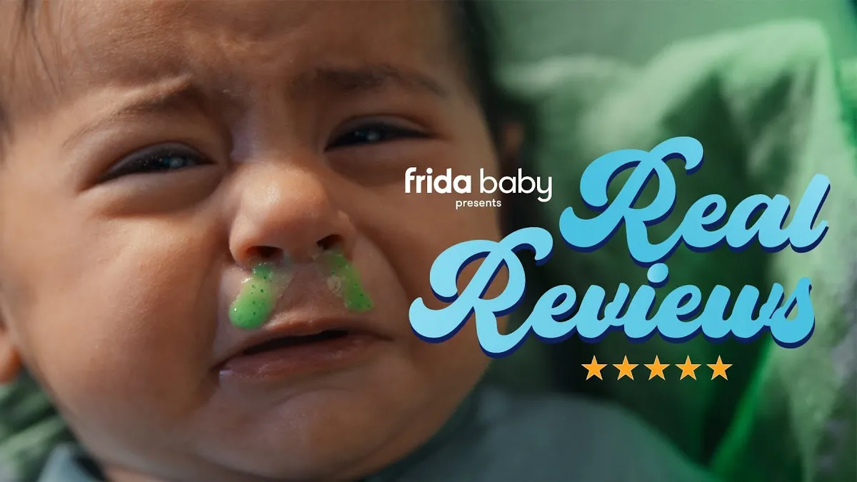 Screenshot of a Frida Baby ad that features an upset baby with green mucus coming out of its nose