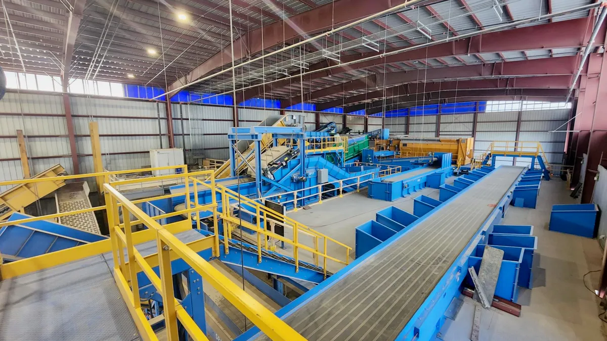 Industrial building with catwalks and sorting lines for recyclables