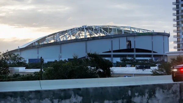 A stadium with a damaged roof.