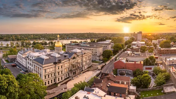 An aerial view of a large government building at sunset