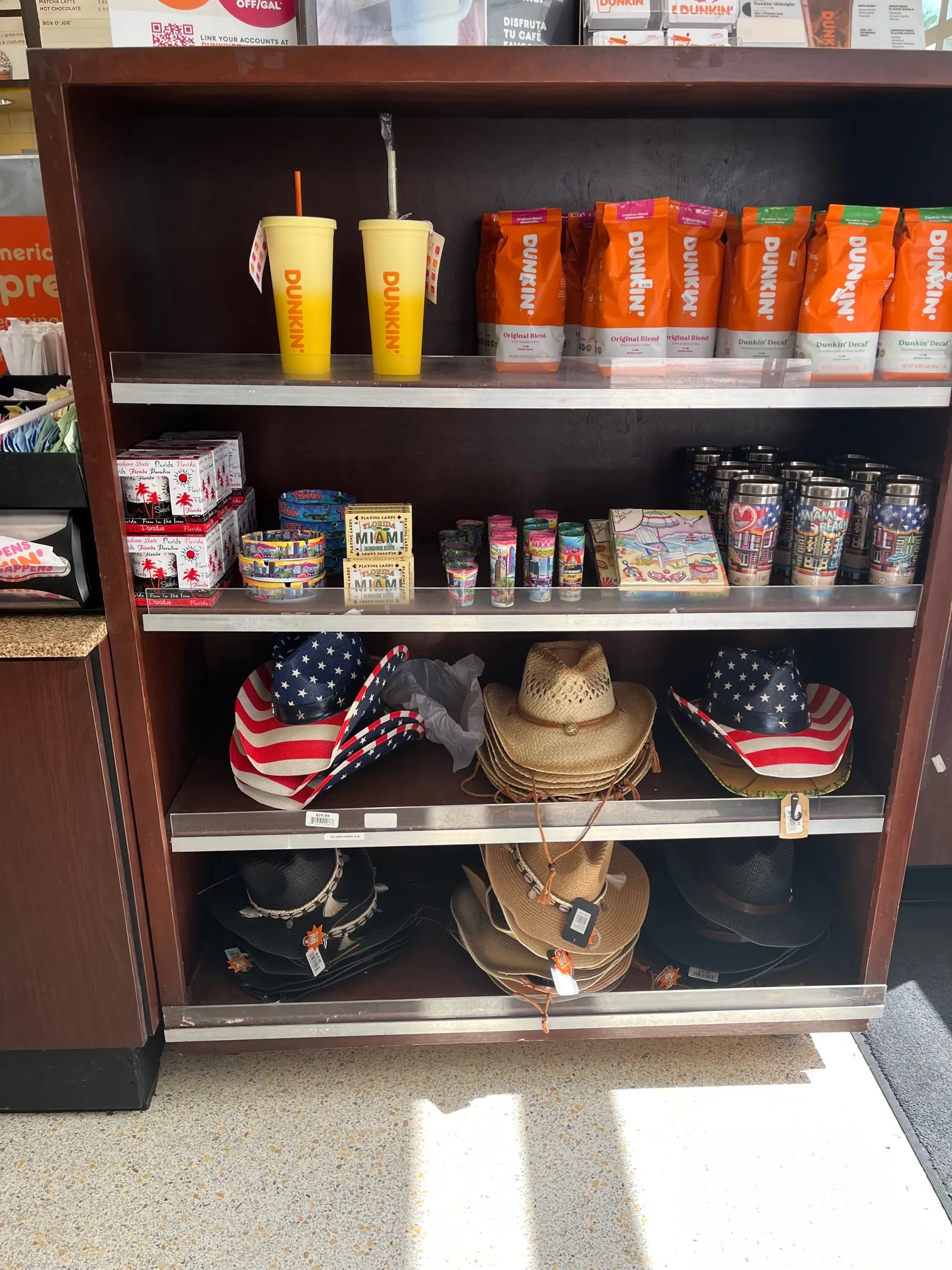 A photo of a display with straw hats, cups, bowls and other ite,s for sale.