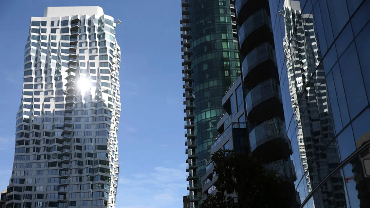 Two reflective skyscrapers catch the sunlight.