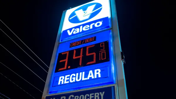 A sign showing gas prices.