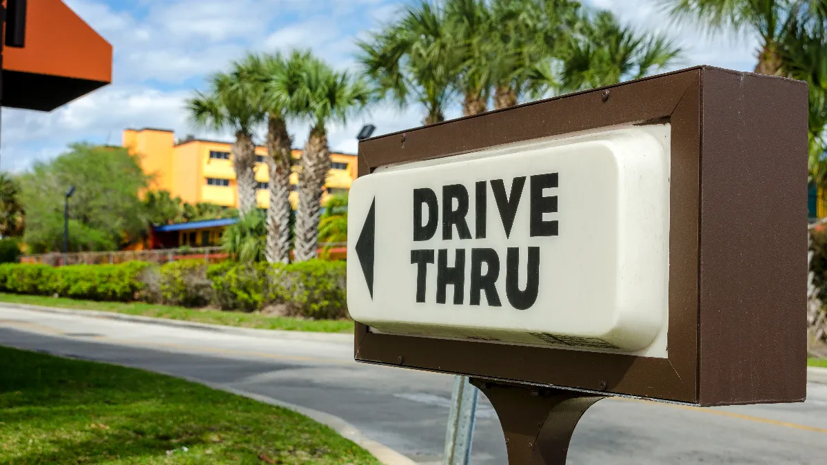 A drive thru sign advertising a fast food restaurant