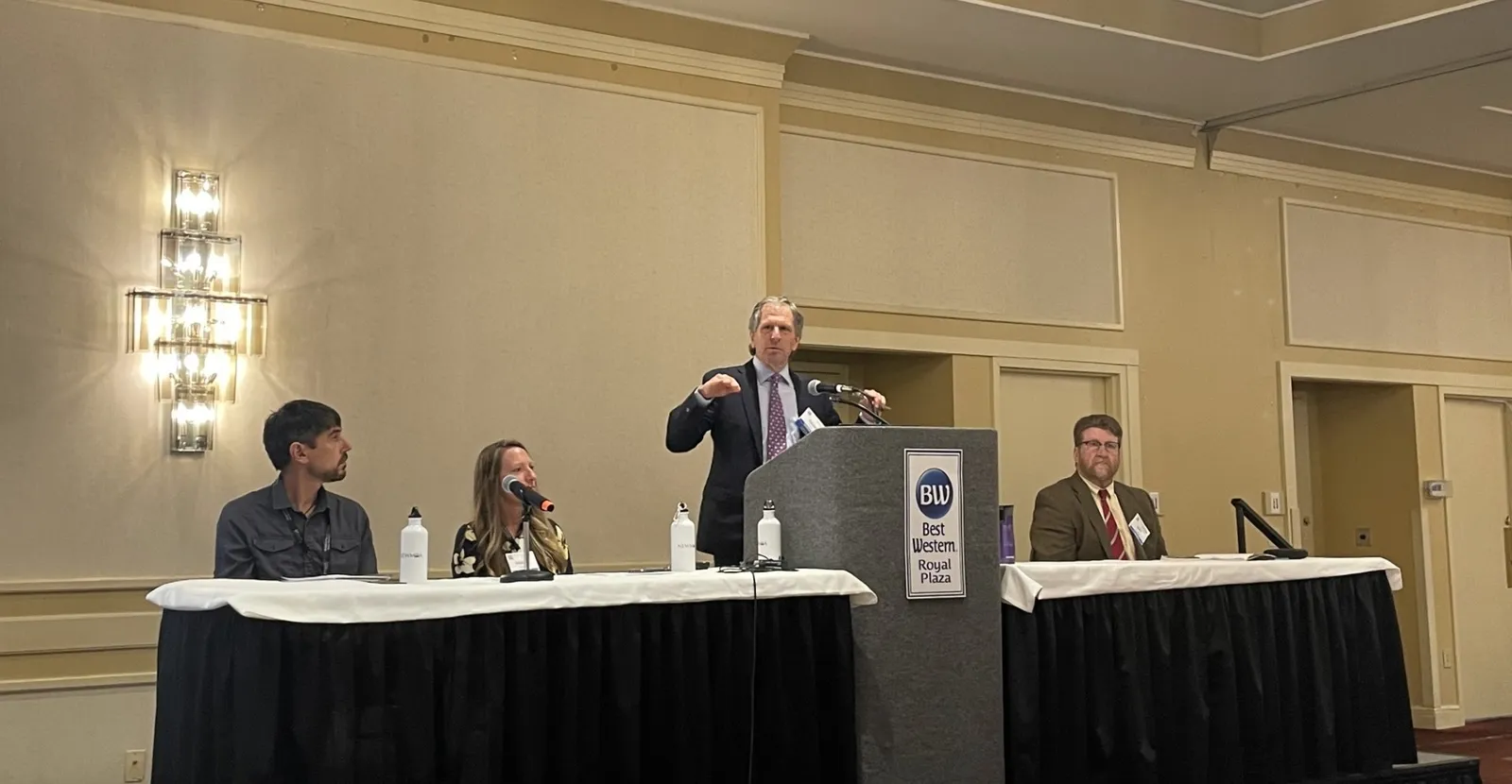 David Cash from the U.S. EPA speaks at a podium, alongside other presenters, during a PFAS conference.