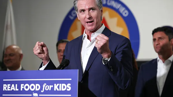 California Governor Gavin Newsom is seen speaking behind a podium