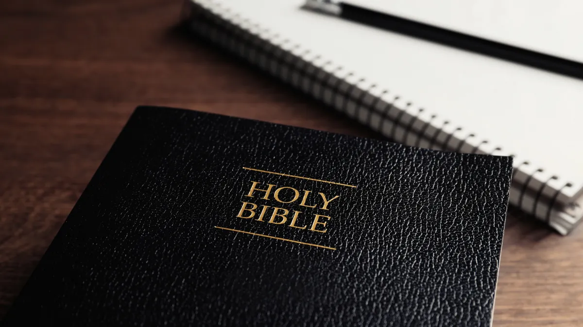 A Bible lays next to a notebook