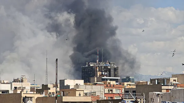 Plumes of smoke rise over the skyline following explosions on March 1, 2026 in Tehran, Iran.
