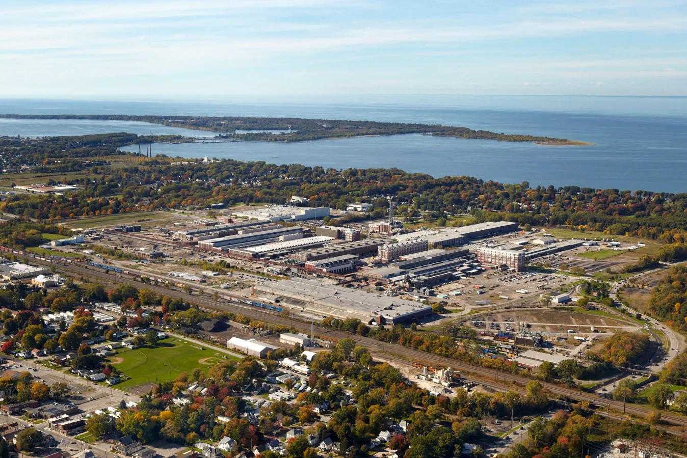 Wabtec's manufacturing plant in Erie, Pennsylvania with green landscape and a body of water behind it.