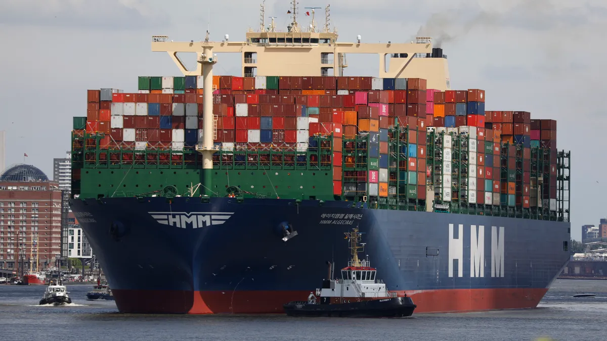 A containership departs from Hamburg Port.