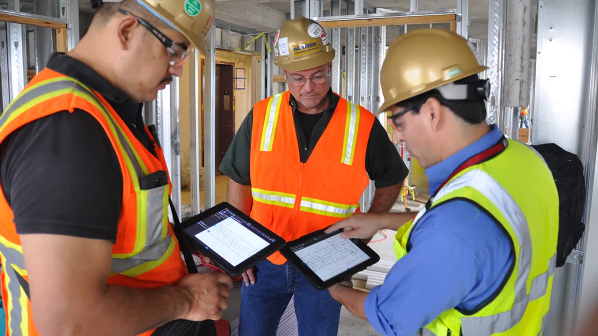 Construction personnel going over plans on construction site