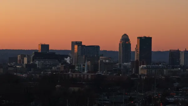 A skyline silhouette with orange sky