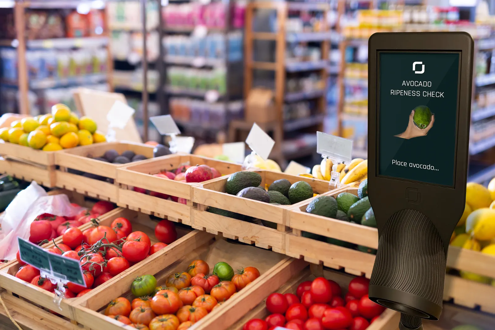 An "avocado ripeness check" device in the produce section of a grocery store.