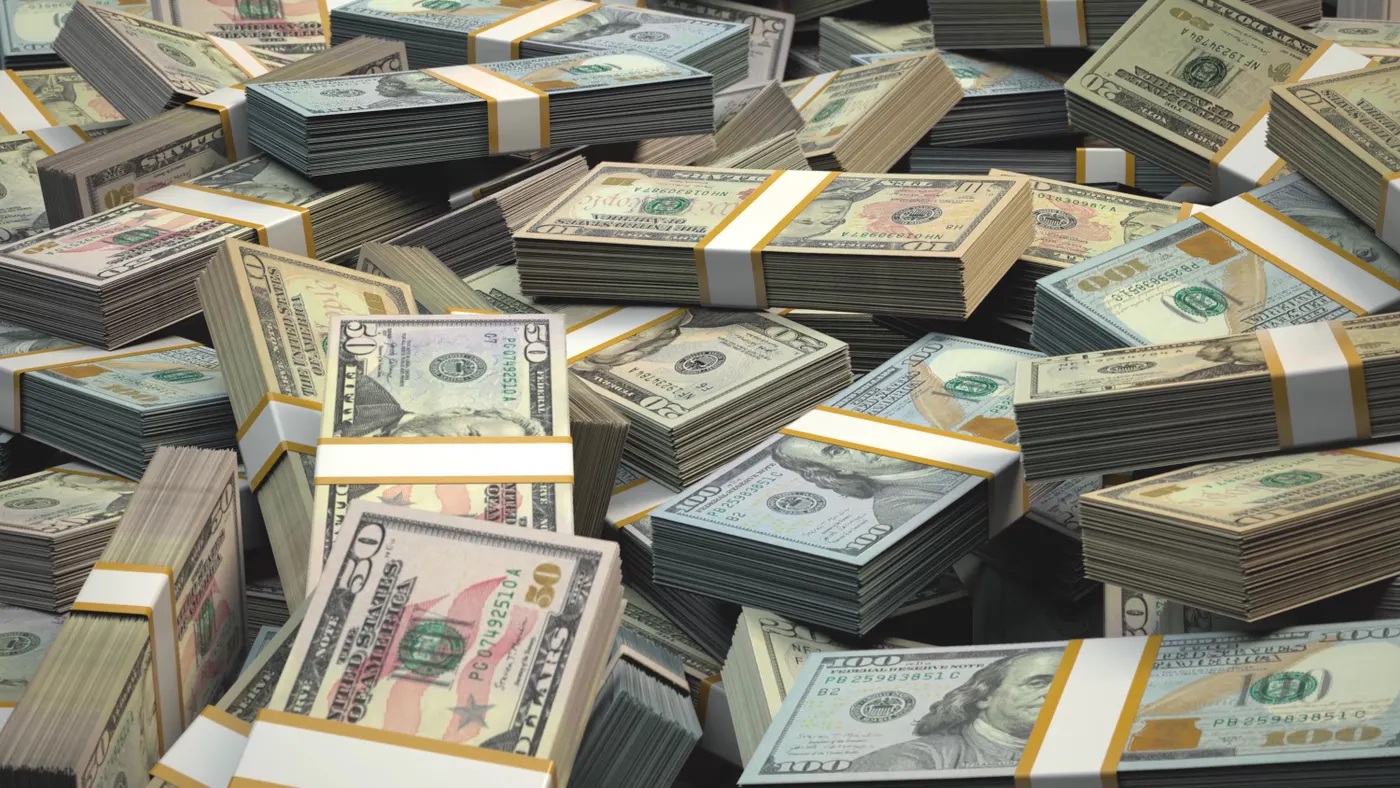 Stacks of U.S. fifty and one hundred dollar bills are shown.