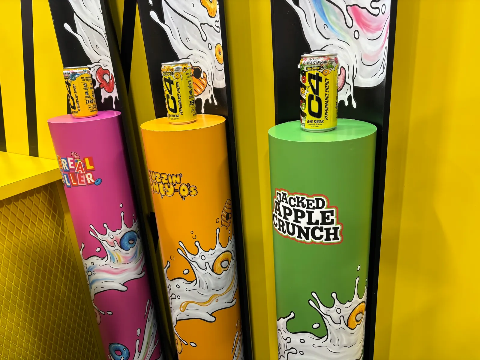 An image of C4 energy drink cans on pedestals.