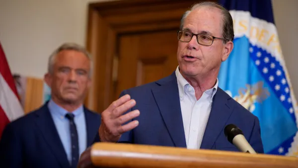 A man speaks at a podium.