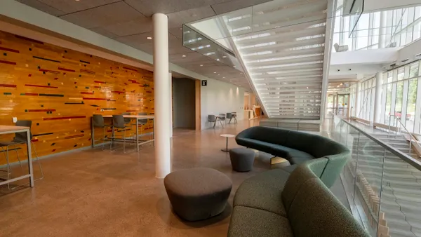 The second floor of the Highmark Center for Health, Wellness and Athletics, with lounging sofas and desks in the foreground.