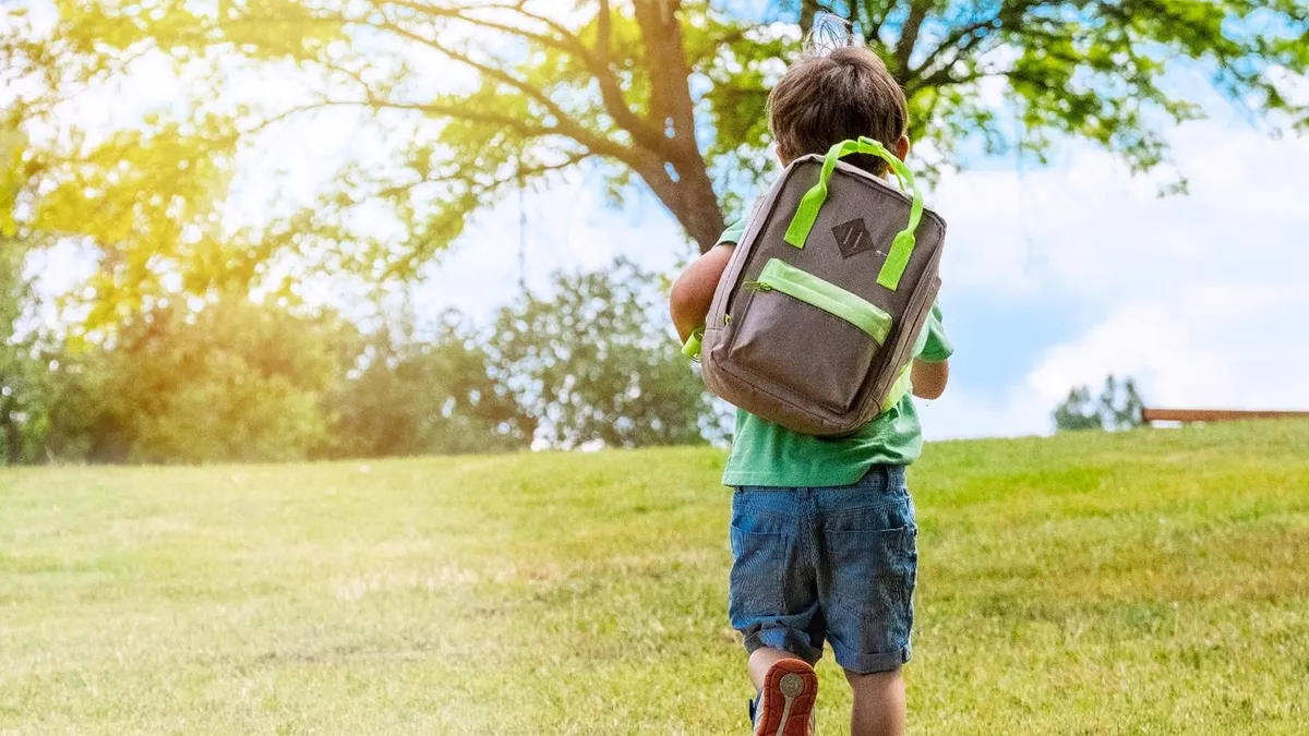 Boy with a back pack running