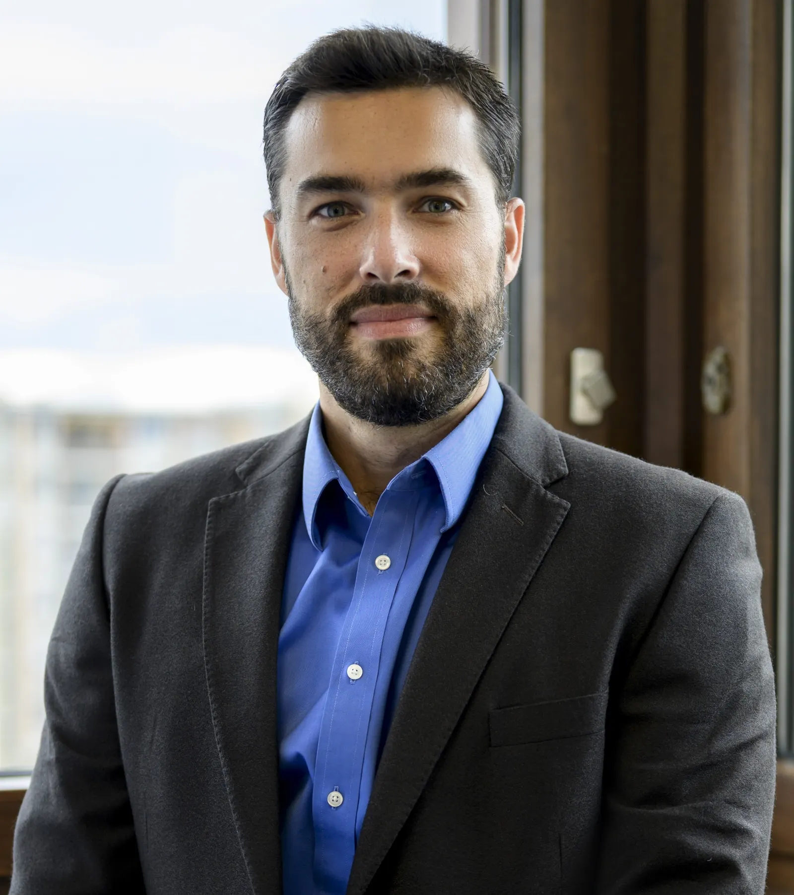 Headshot of Greg Garrett, standing in front of a window.