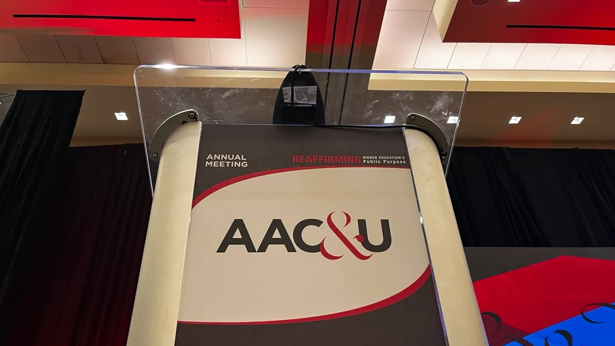 A podium that reads "AAC&U"