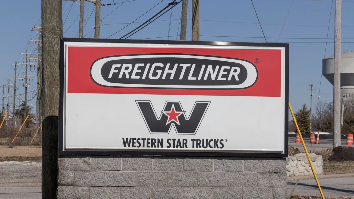 A sign shows Freightliner and Western Star logos.