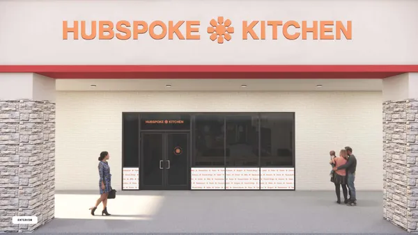 An image of a beige storefront with an orange logo that says "Hubspoke Kitchen"