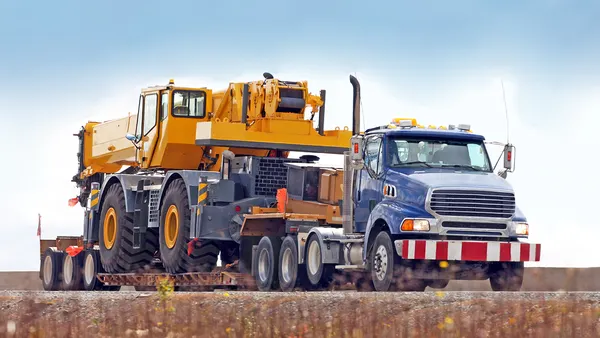 truck transporting mobile crane