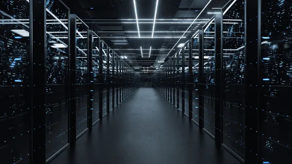 a server room aisle with server racks at either side