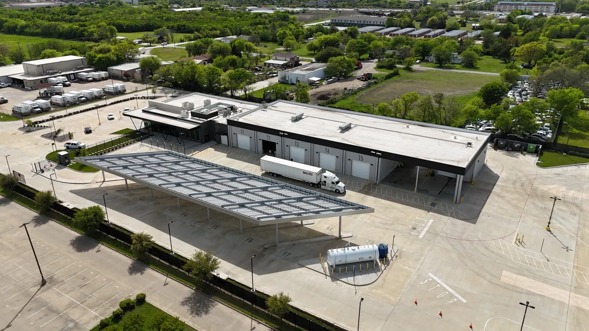 An aerial shot of Waabi's autonomous trucking terminal in Lancaster, Texas, showing a tractor-trailer.