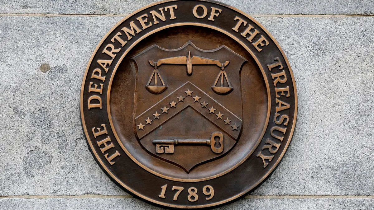 The brown-and-gold seal of the Treasury Department is seen on the wall of its headquarters building