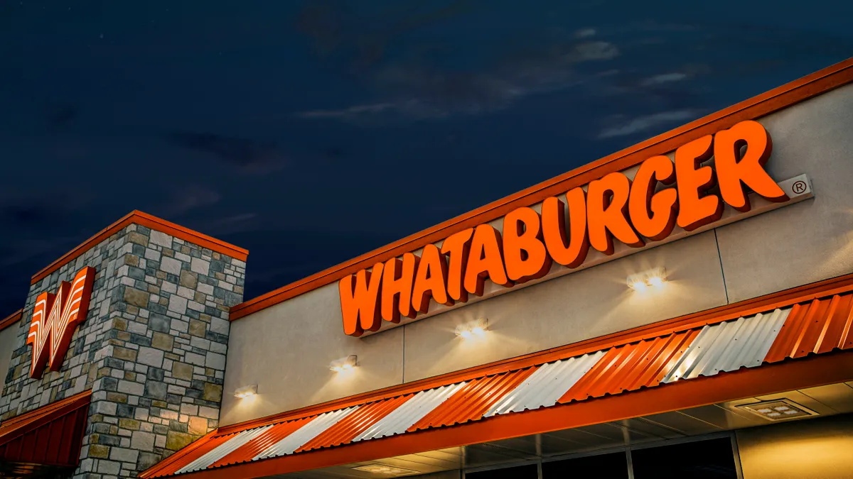 A Whatburger storefront. A sign outside reads, "Whataburger".